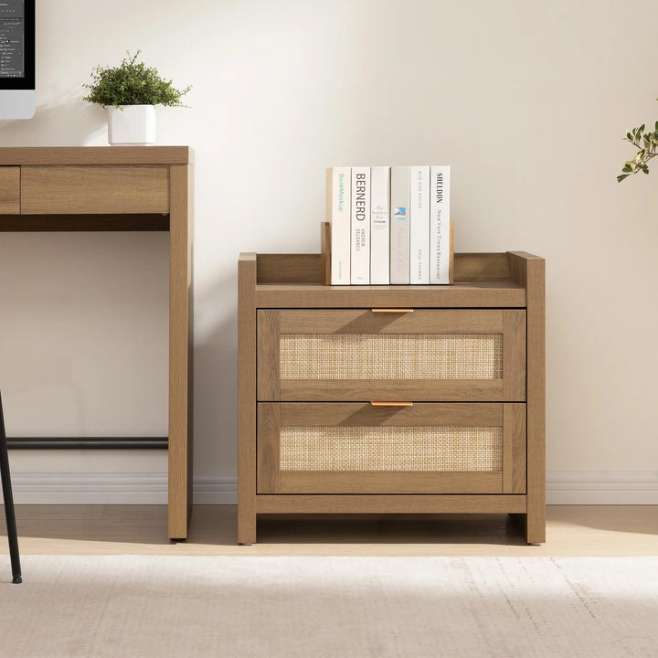 Wooden nightstand with rattan drawers, books on top, next to matching desk in a modern room