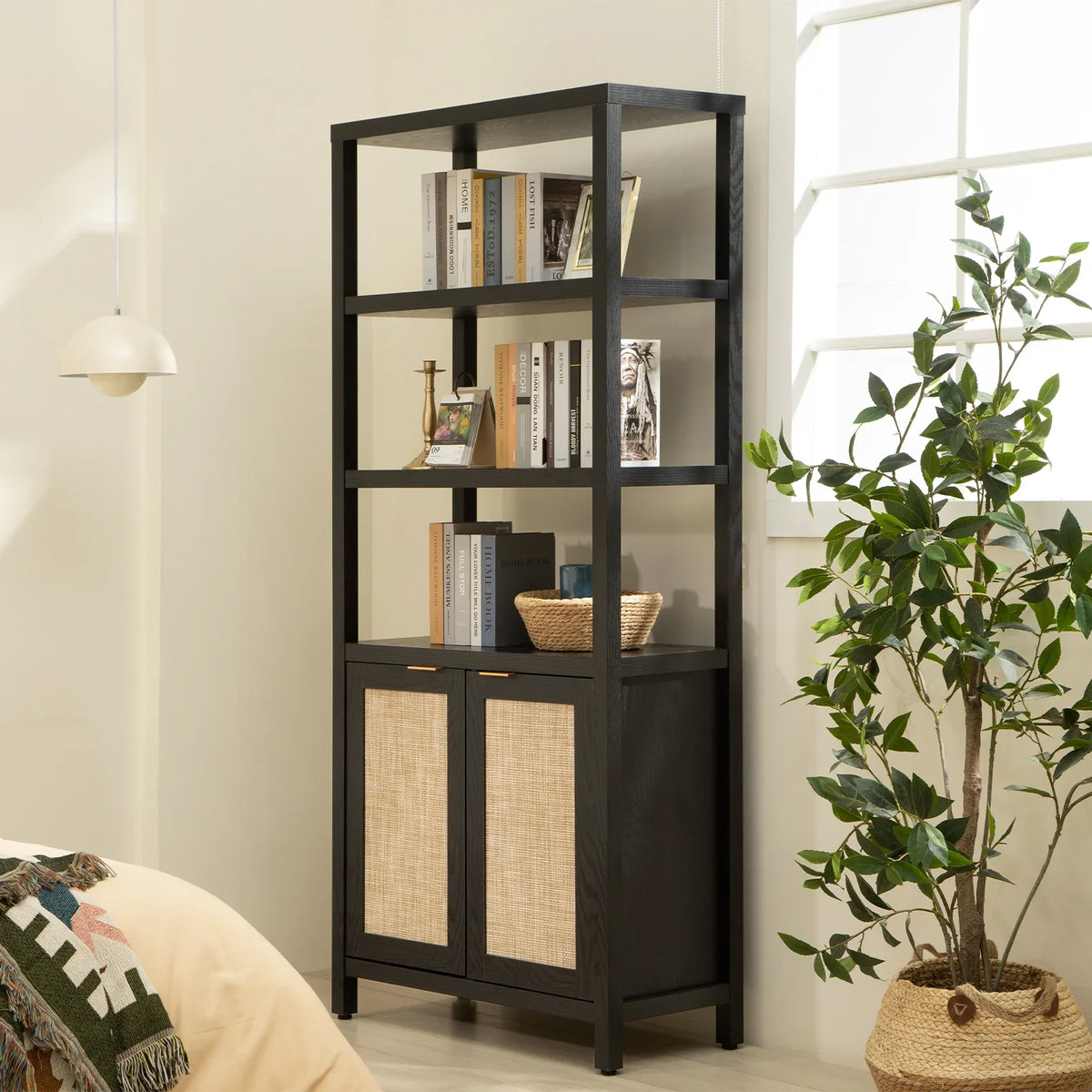 Modern black bookshelf with books, decor, and rattan cabinet doors in a bright living room