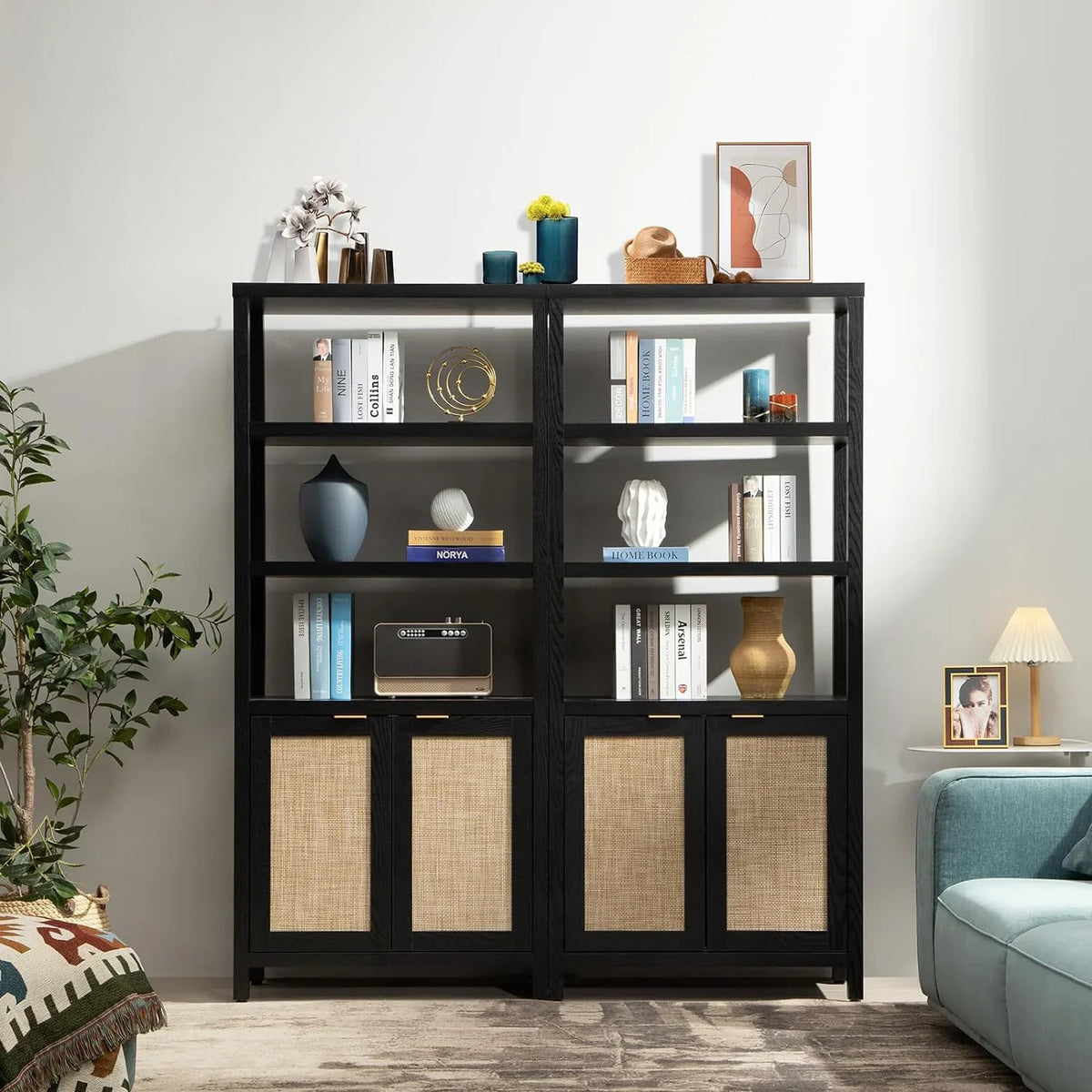 Modern black bookshelf with decor, books, rattan cabinet doors in stylish living room