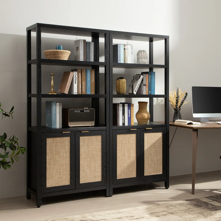 Modern black wood bookshelf with rattan cabinet doors, books, decor, and office desk setup
