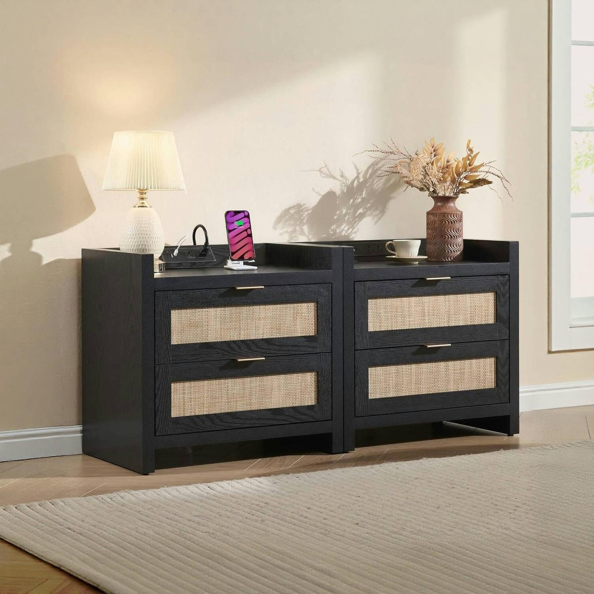 Modern black nightstands with rattan drawers, lamp, vase, and decor in a bright bedroom