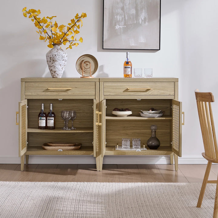 Modern light wood sideboard with open shelves, glassware, bottles, and yellow floral vase
