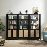 Modern black bookshelf with books, decorative vases, art, and wicker cabinet doors in living room