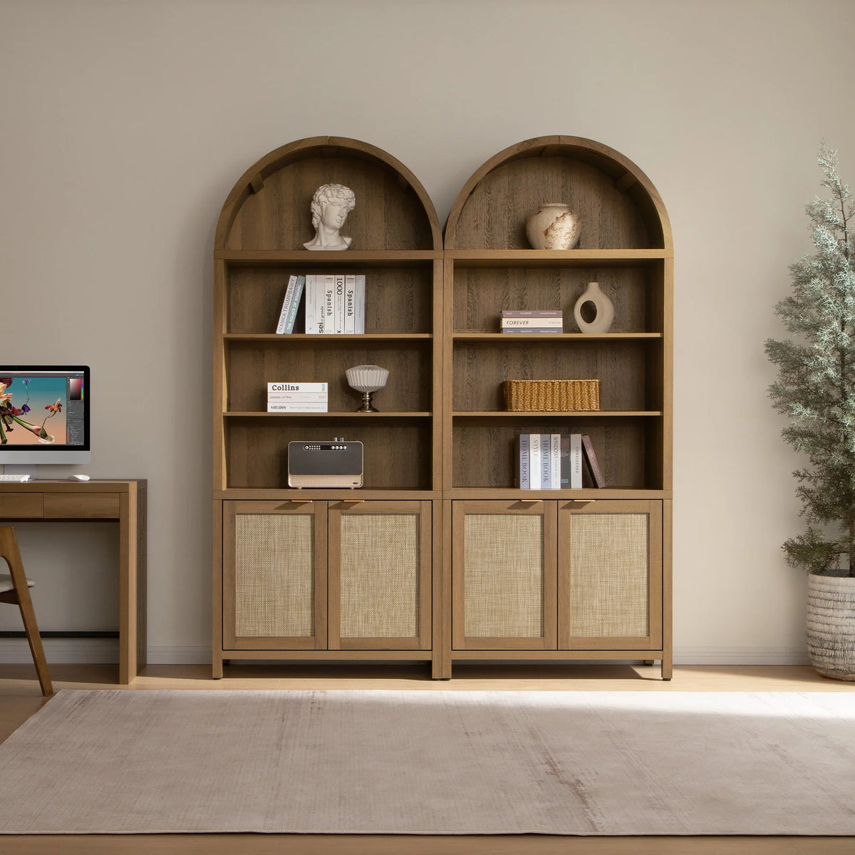 Modern home office with wooden arched bookshelves, desktop computer, and decor accents