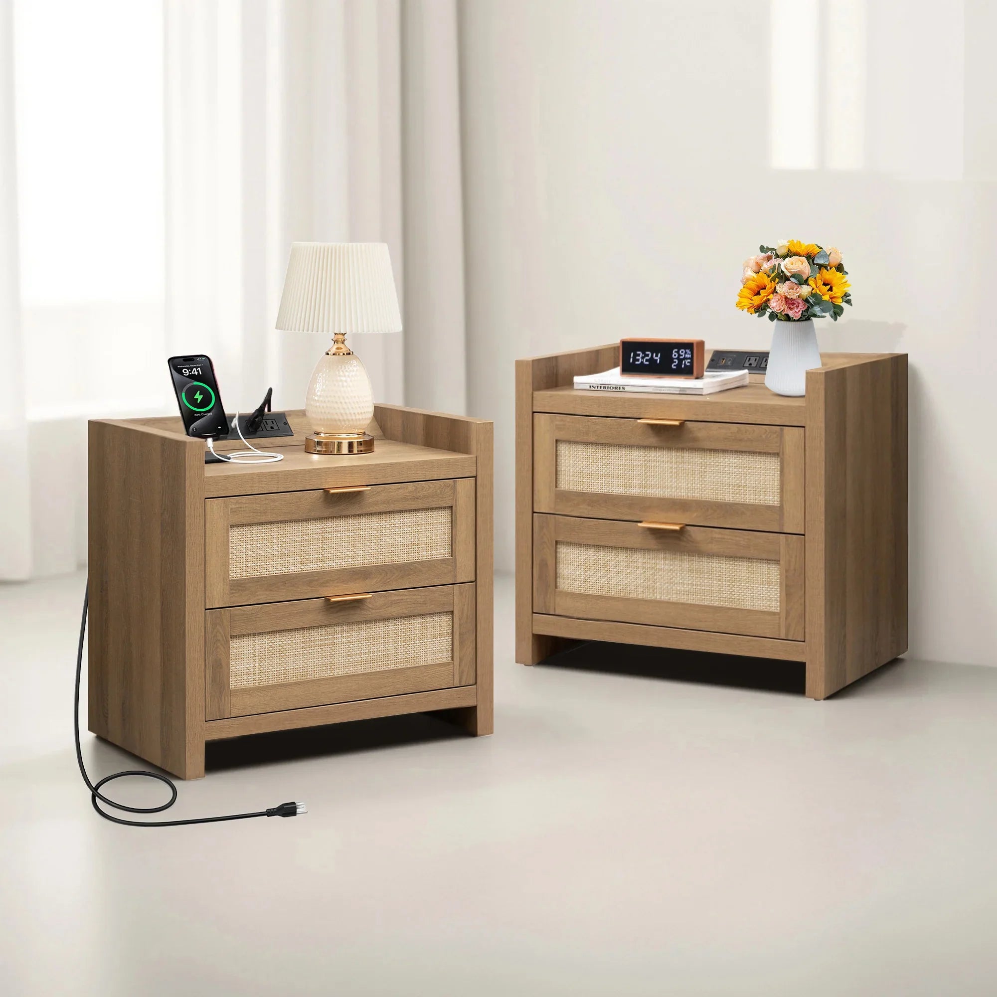 Set of two modern wooden nightstands with drawers, lamp, charging phone, flowers, and clock.
