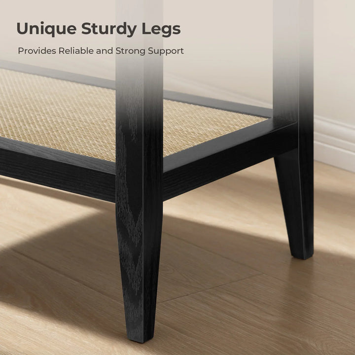 Black wooden furniture legs with woven rattan shelf on light wood floor