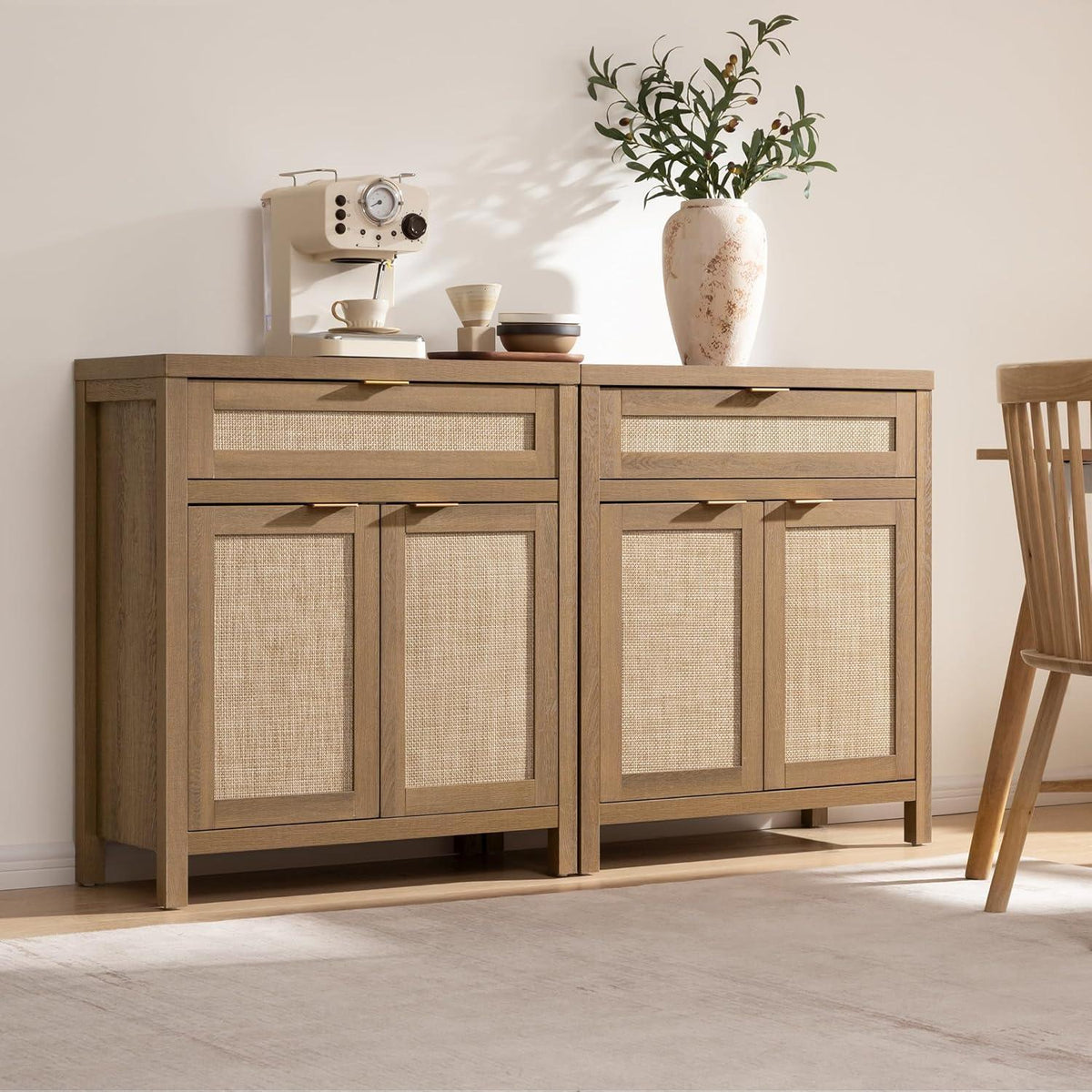 Modern wood sideboard with woven panel doors, coffee maker, ceramic cups, and a vase with green branches