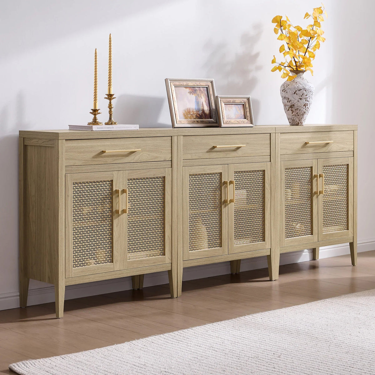 Light wood buffet cabinet with rattan doors, gold handles, and decorative accents