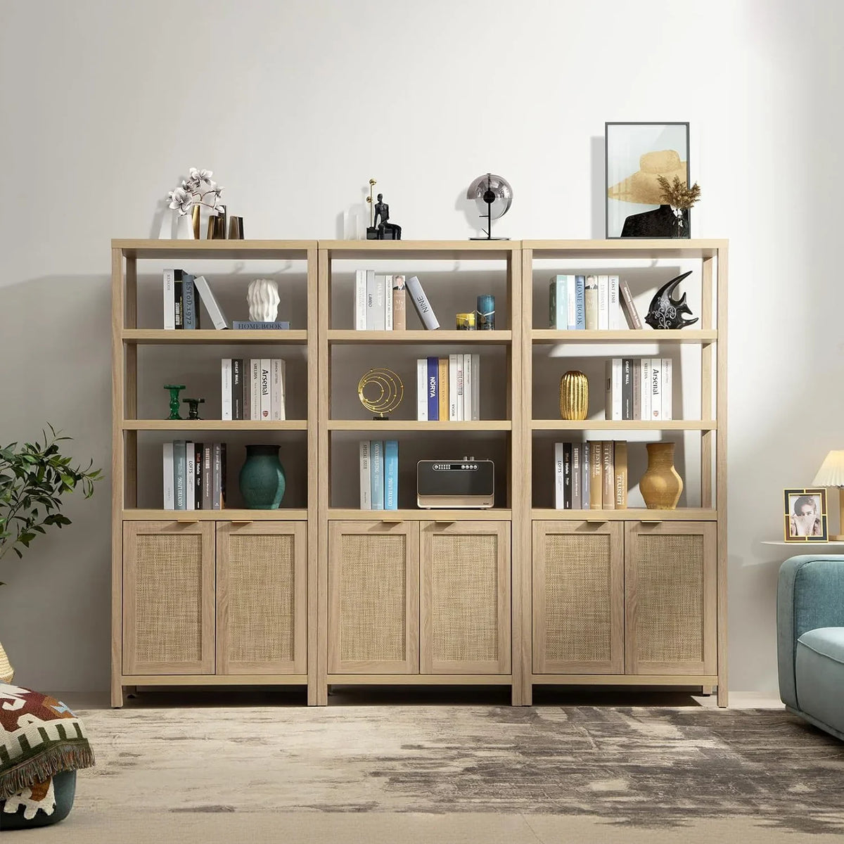 Modern wooden bookshelf with books, decorative vases, art, cabinets, and minimalist decor