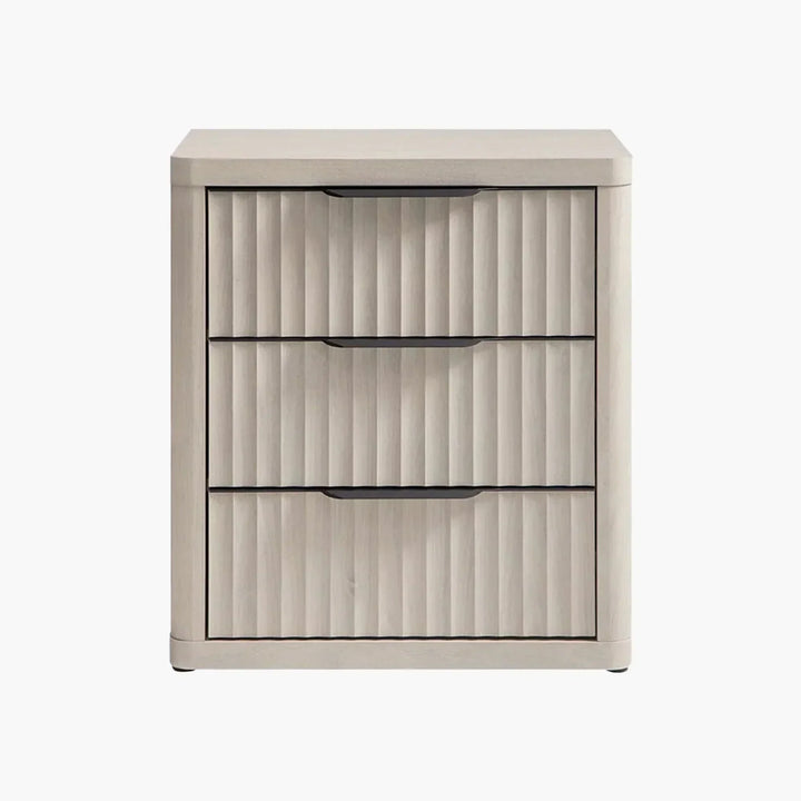 Light wood three-drawer nightstand with vertical grooves and black handles