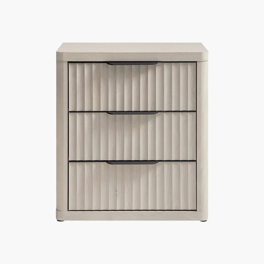 Light wood three-drawer nightstand with vertical grooves and black handles