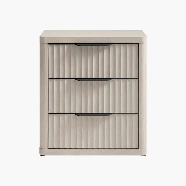 Light wood three-drawer nightstand with vertical grooves and black handles