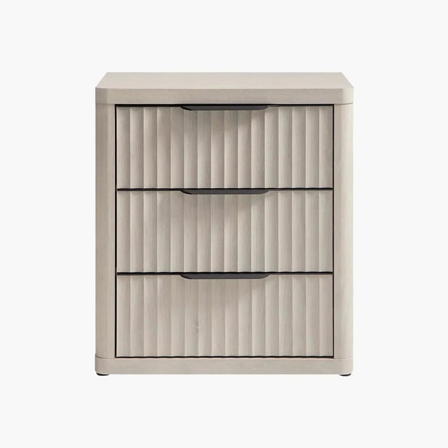 Light wood three-drawer nightstand with vertical grooves and black handles