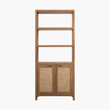 Modern wooden bookshelf with three open shelves and two rattan cabinet doors on white background.