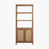 Modern wooden bookshelf with three open shelves and two rattan cabinet doors on white background.