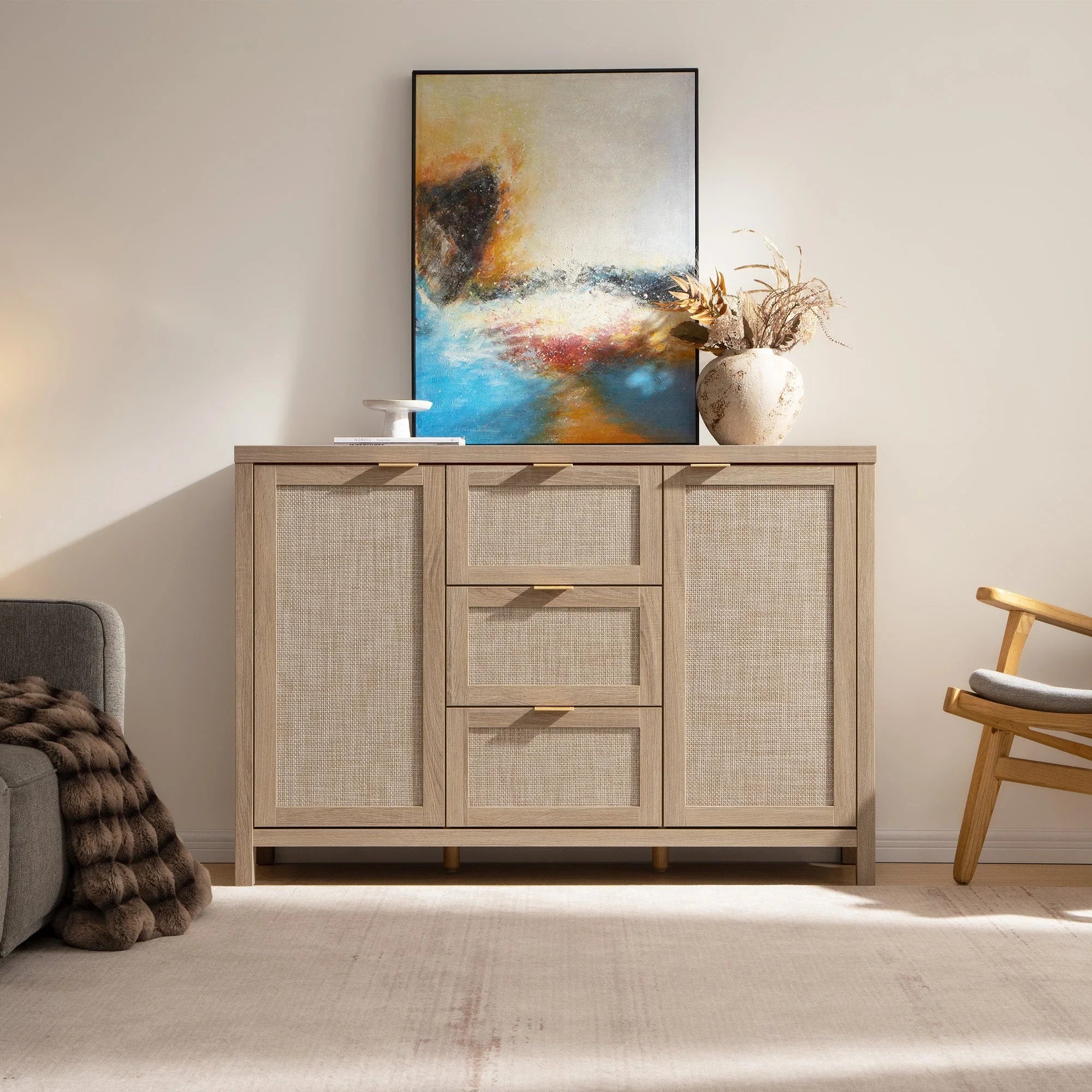 Savanna sideboard cabinet with rattan doors, abstract wall art, and ceramic vase in modern living room